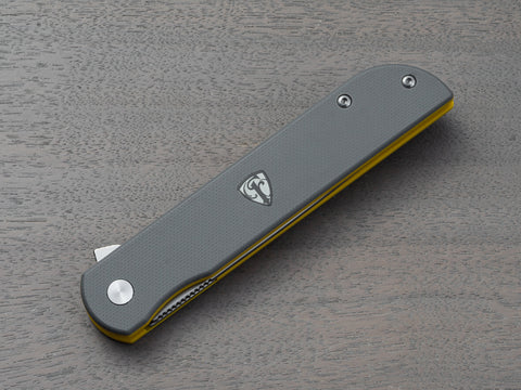 Gray and yellow handle on a pocket knife from Finch