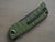 Folding knife with green handle and black blade