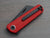 RUNTLY pocket knife with clip. Red handle and black blade. Folding knife in closed position.